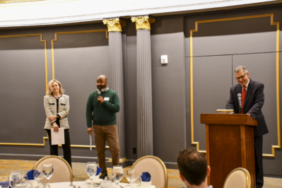 Vanessa Denney and Wayne Brown speak with  Mark Weber in front of the CAP graduates